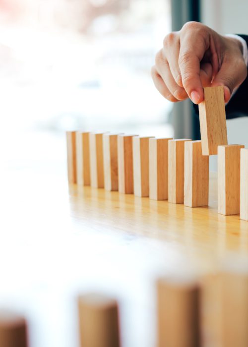 Businessman hand pick one of wood block in row with leadership concept